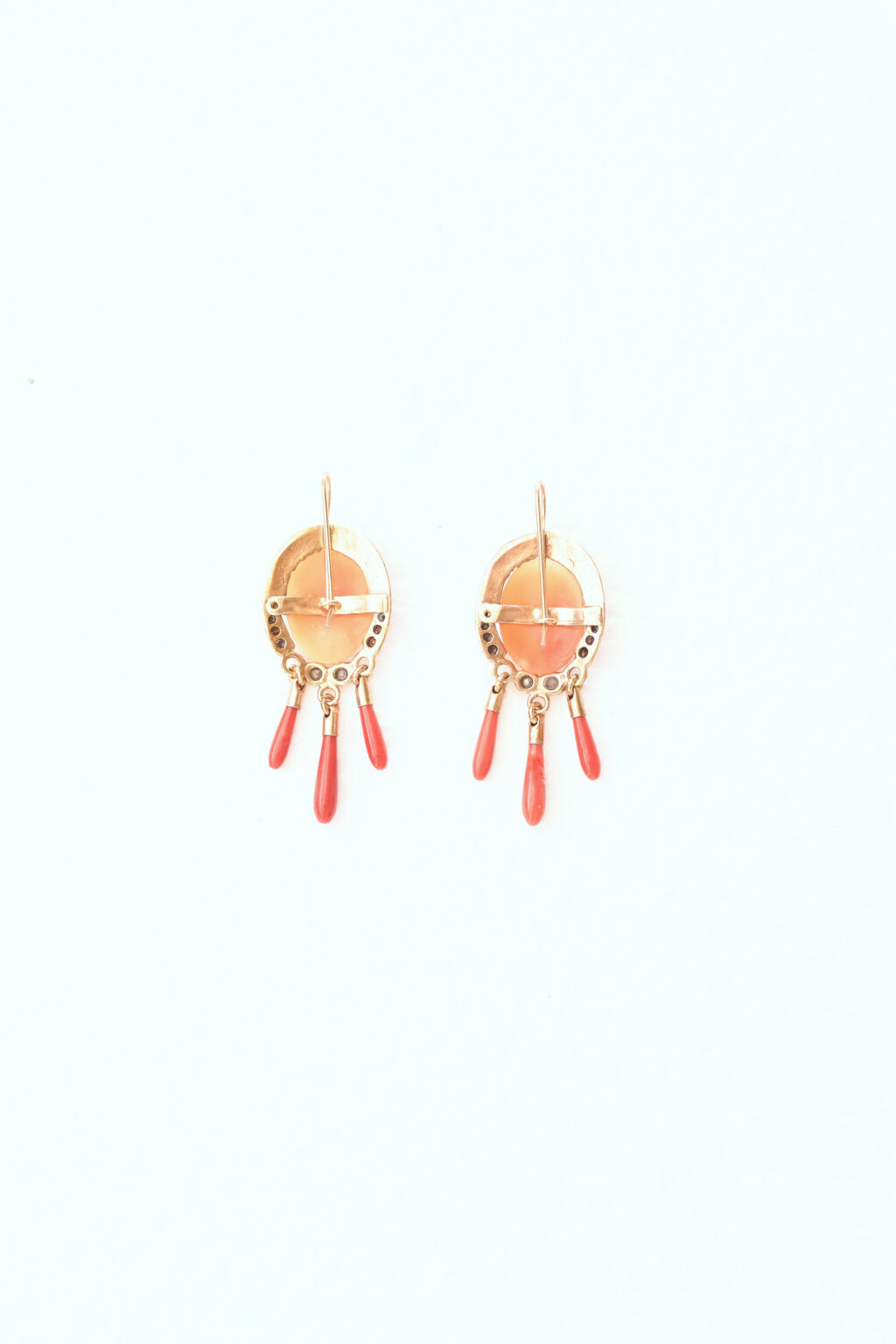 Dangling cameo earrings with red coral drops