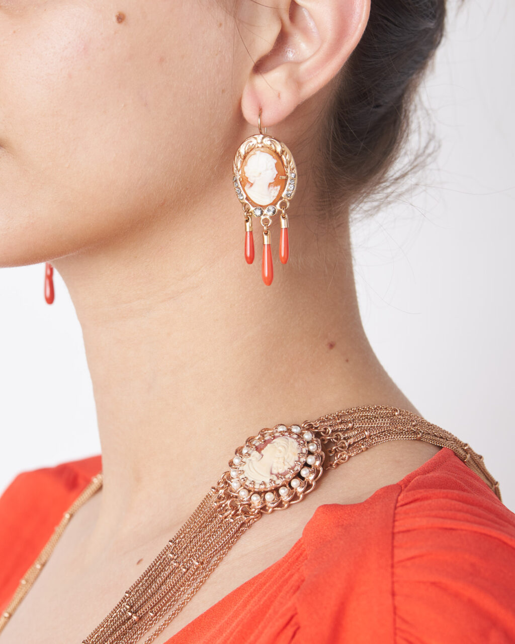 Dangling cameo earrings with red coral drops